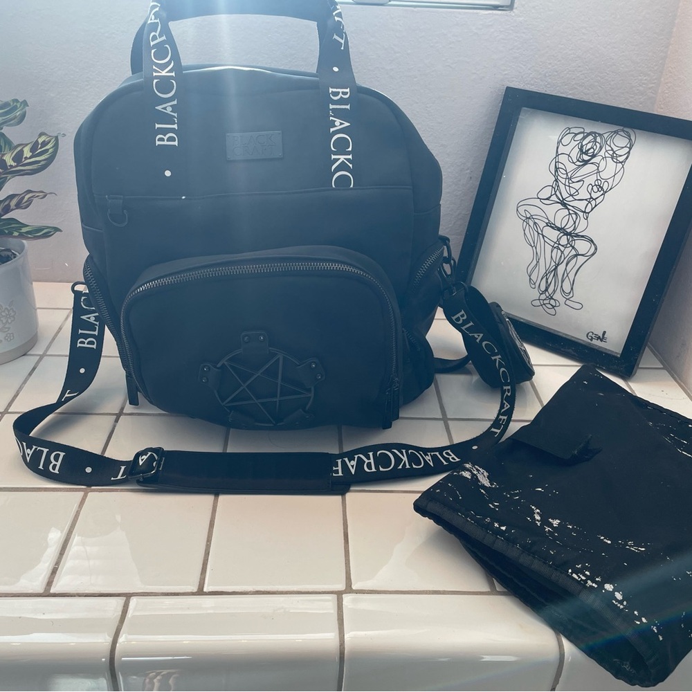 Black Craft Diaper Bag with changing mat, and pacifier holder.